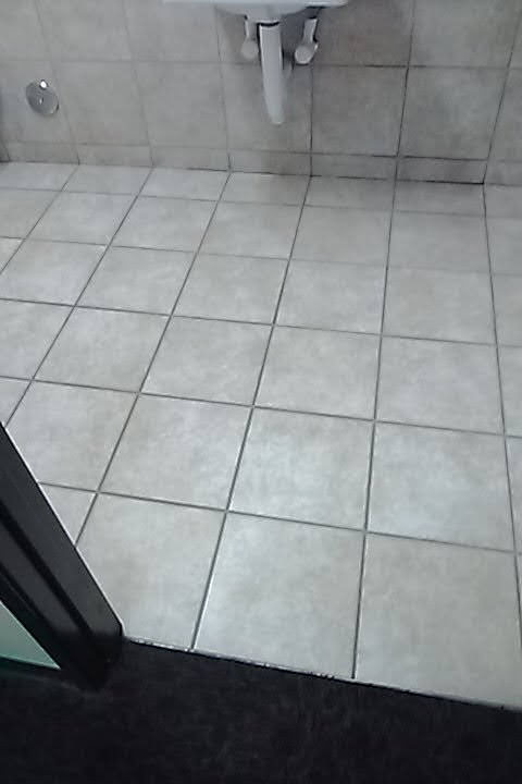 A clean light tile floor with tidy grout lines