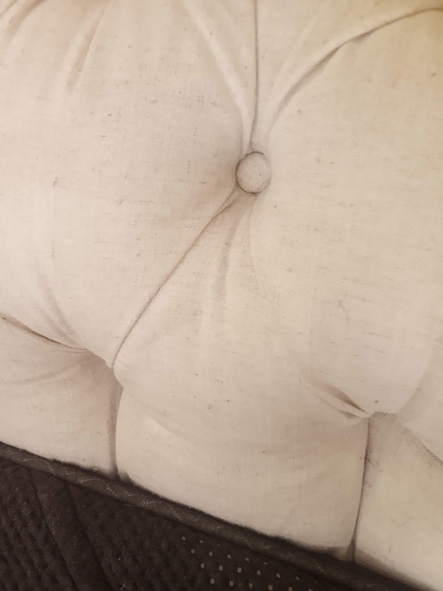 A cream tufted sofa back after cleaning