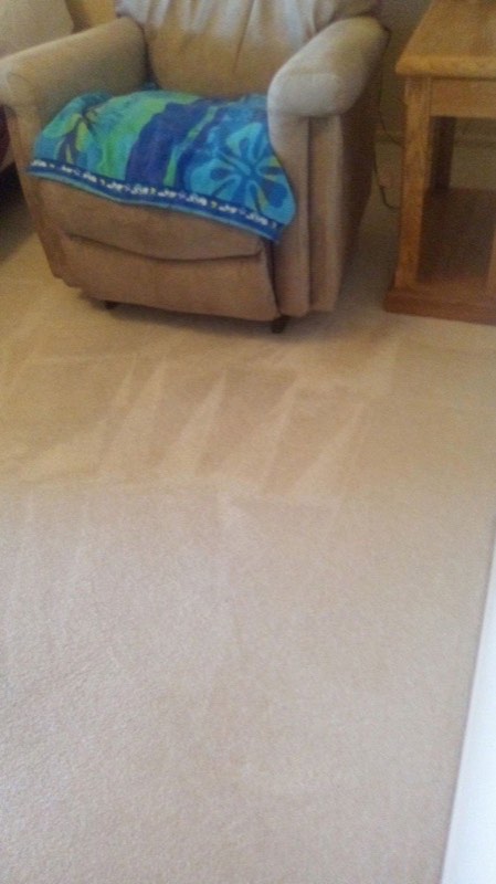 Clean light carpet in front of a recliner
