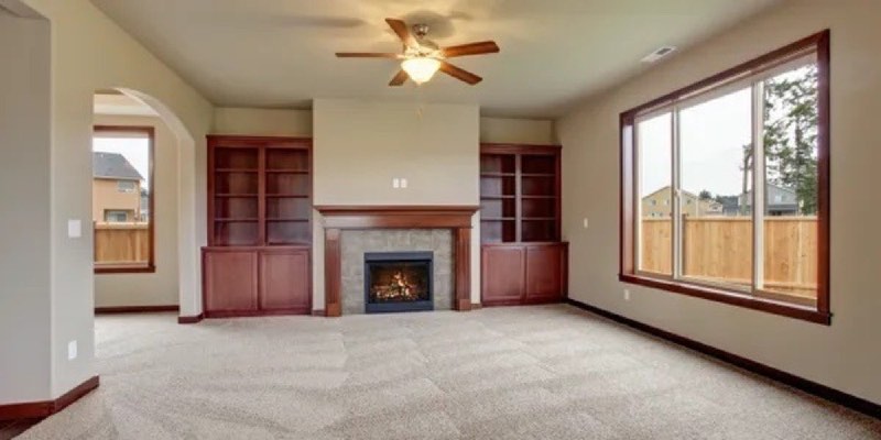 Clean carpet in an empty room with a fireplace